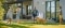 Family enjoying their garden in front of a modern house with an air-to-water carrier heat pump installed on the wall.